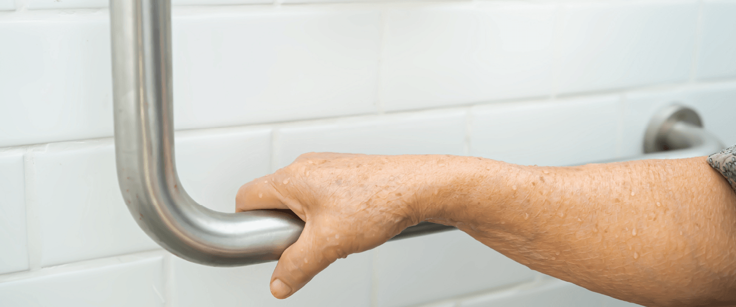 Hand holding toilet bar